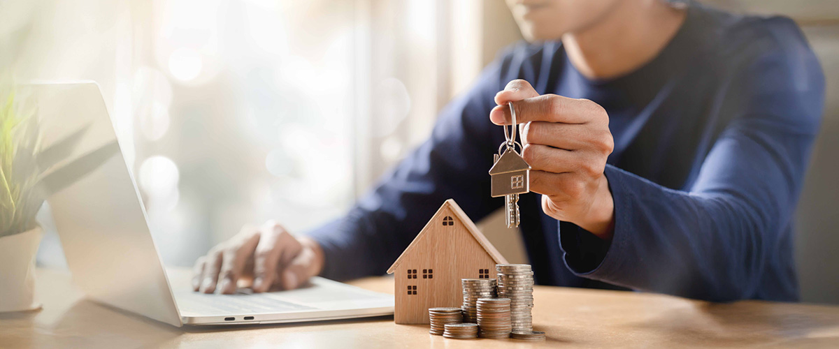 Businessman choosing mini wood house model. Planning to buy property. Choose what's the best. A symbol for construction, ecology, loan concepts.